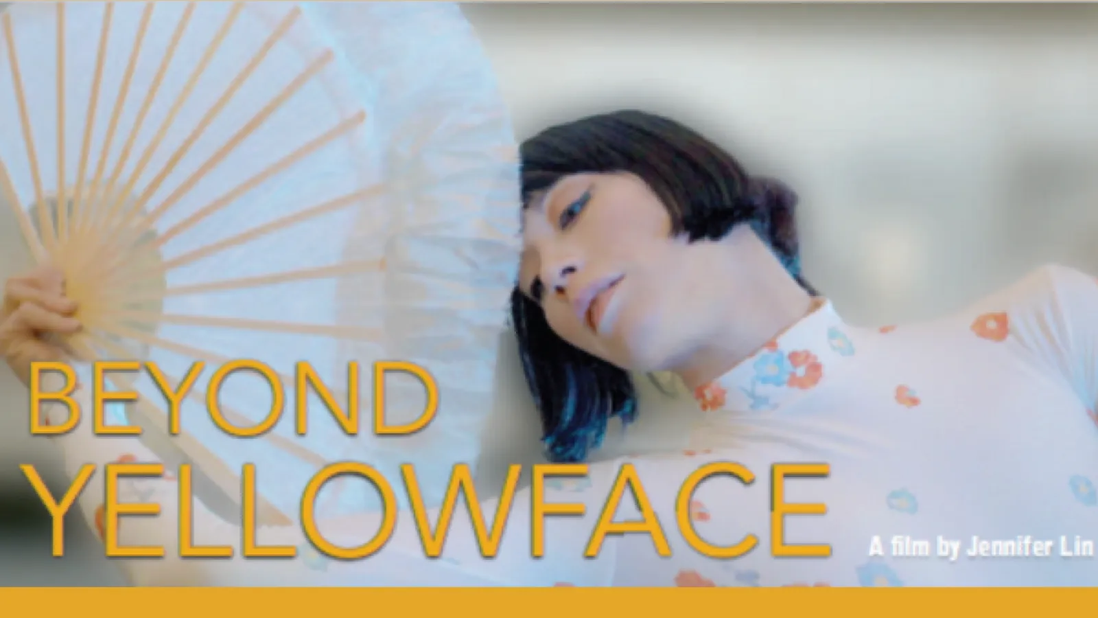 An Asian woman behind a big paper fan