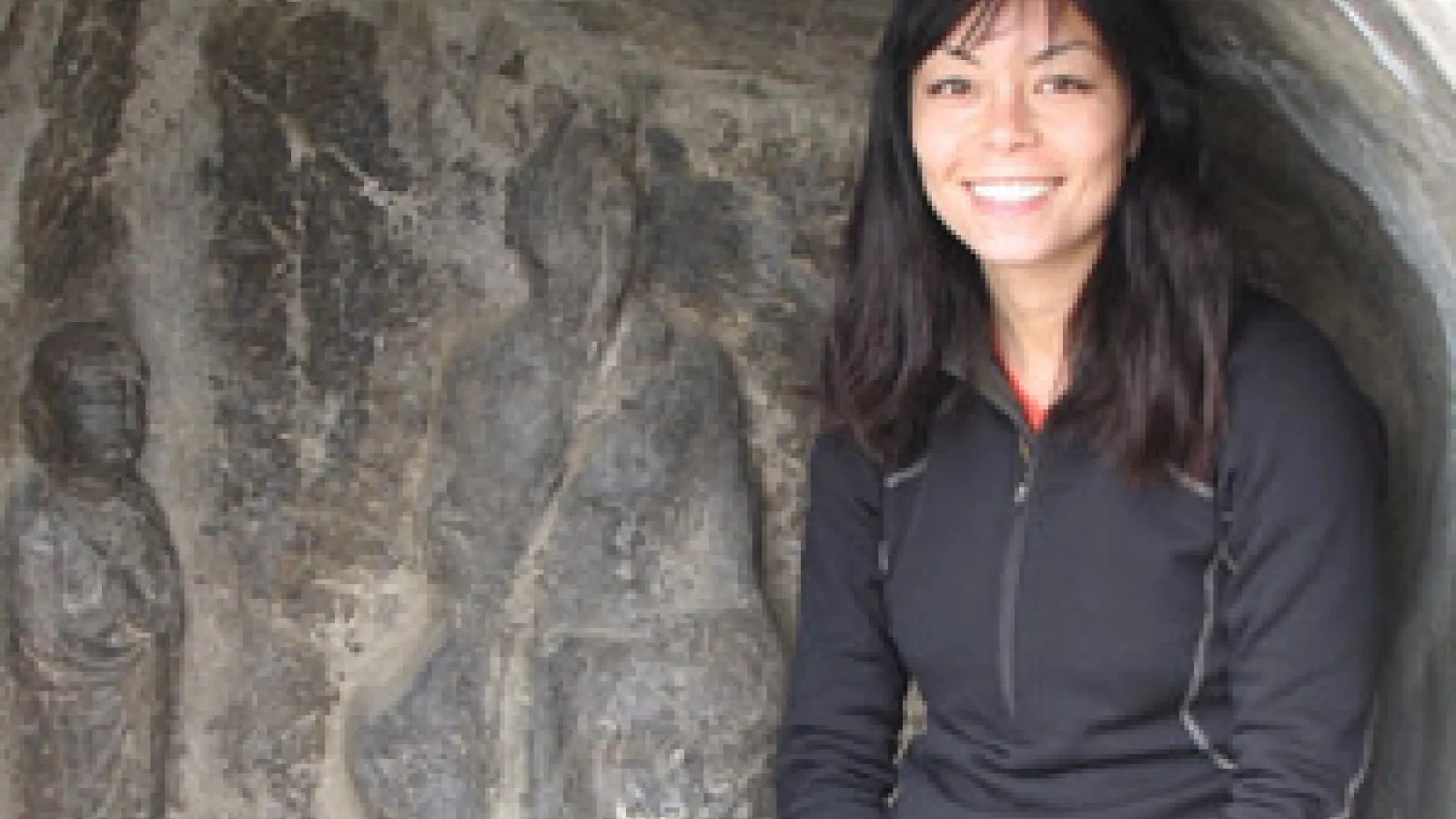 Namiko Kunimoto sitting in front of a gray wall