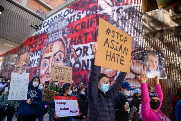 Image of people with signs that say stop Asian hate